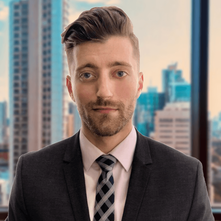 Joshua Cross profile picture standing in a suit in front of a city backdrop